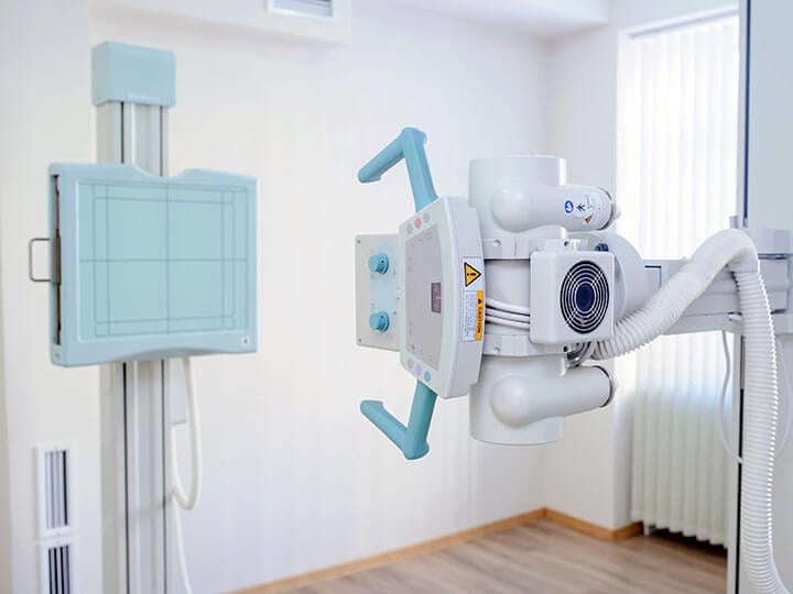 Close up view of white x-ray machine in a radiology room
