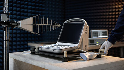 Portable ultrasound system undergoing electromagnetic compatibility testing inside an anechoic chamber.