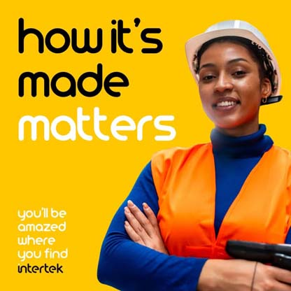 A woman wearing a bright orange vest and hardhat